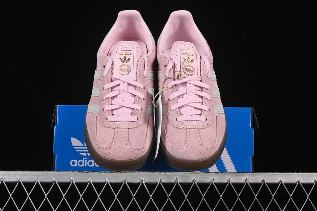 Front view of the sneakers displayed on an adidas shoe box