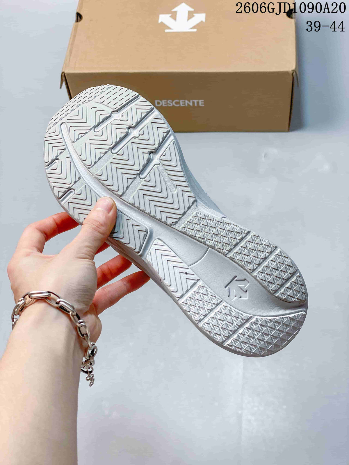 Close-up of the patterned outsole and shoe box