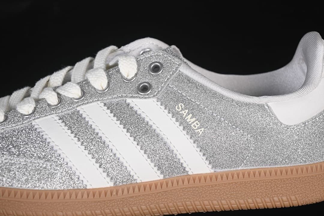 Close-up of the silver glitter-effect upper, white stripes, laces and gum-colored sole.