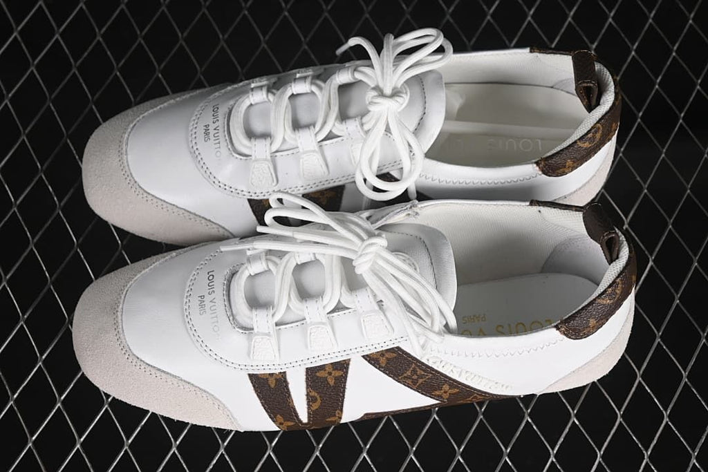 Overhead view of the pair showing the white uppers, brown patterned accents, and beige toe overlays.