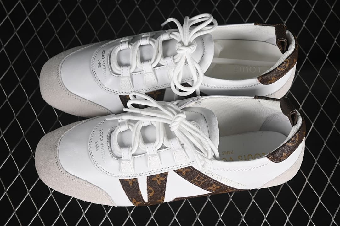 Overhead view of the pair showing the white uppers, brown patterned accents, and beige toe overlays.