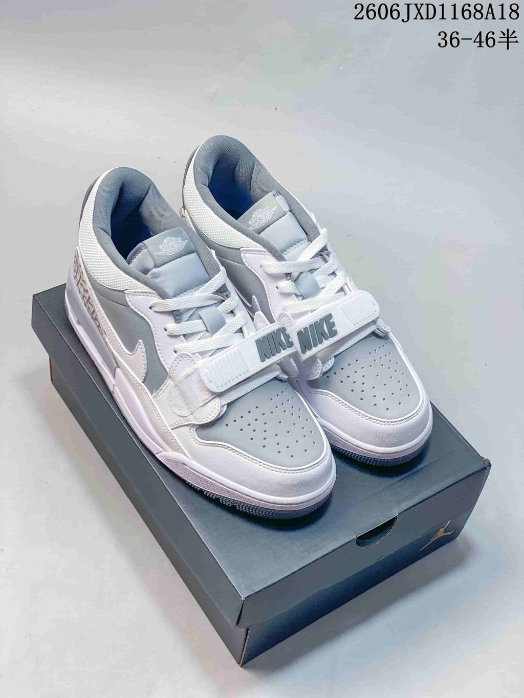 Pair of white and grey Jordan Legacy 312 low-top sneakers with forefoot straps