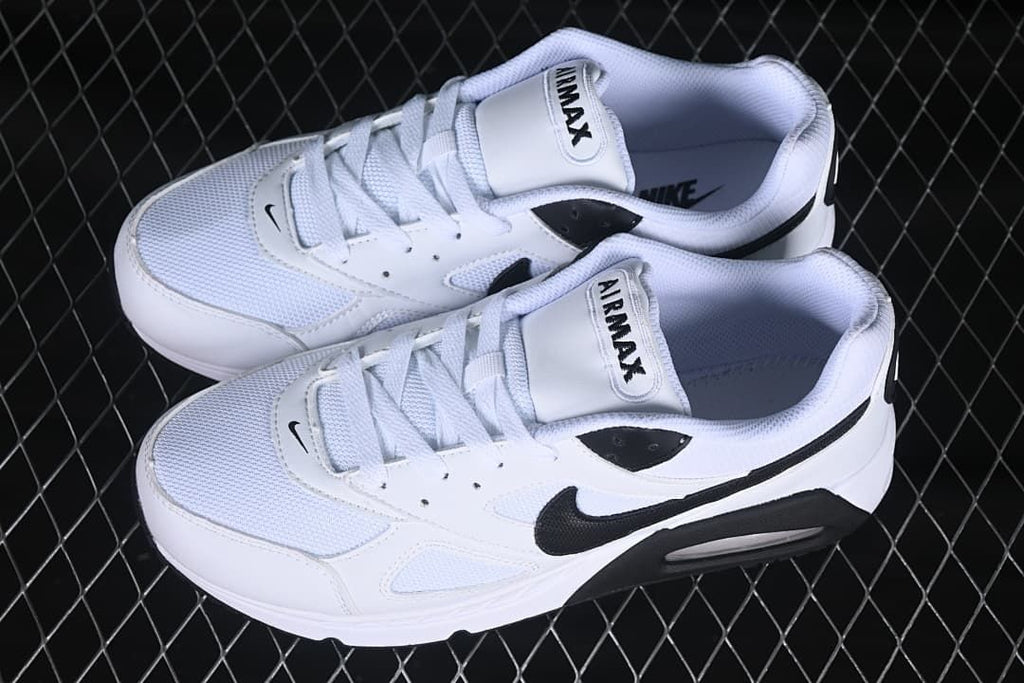 Pair of white and black Air Max Correlate sneakers shown from above.