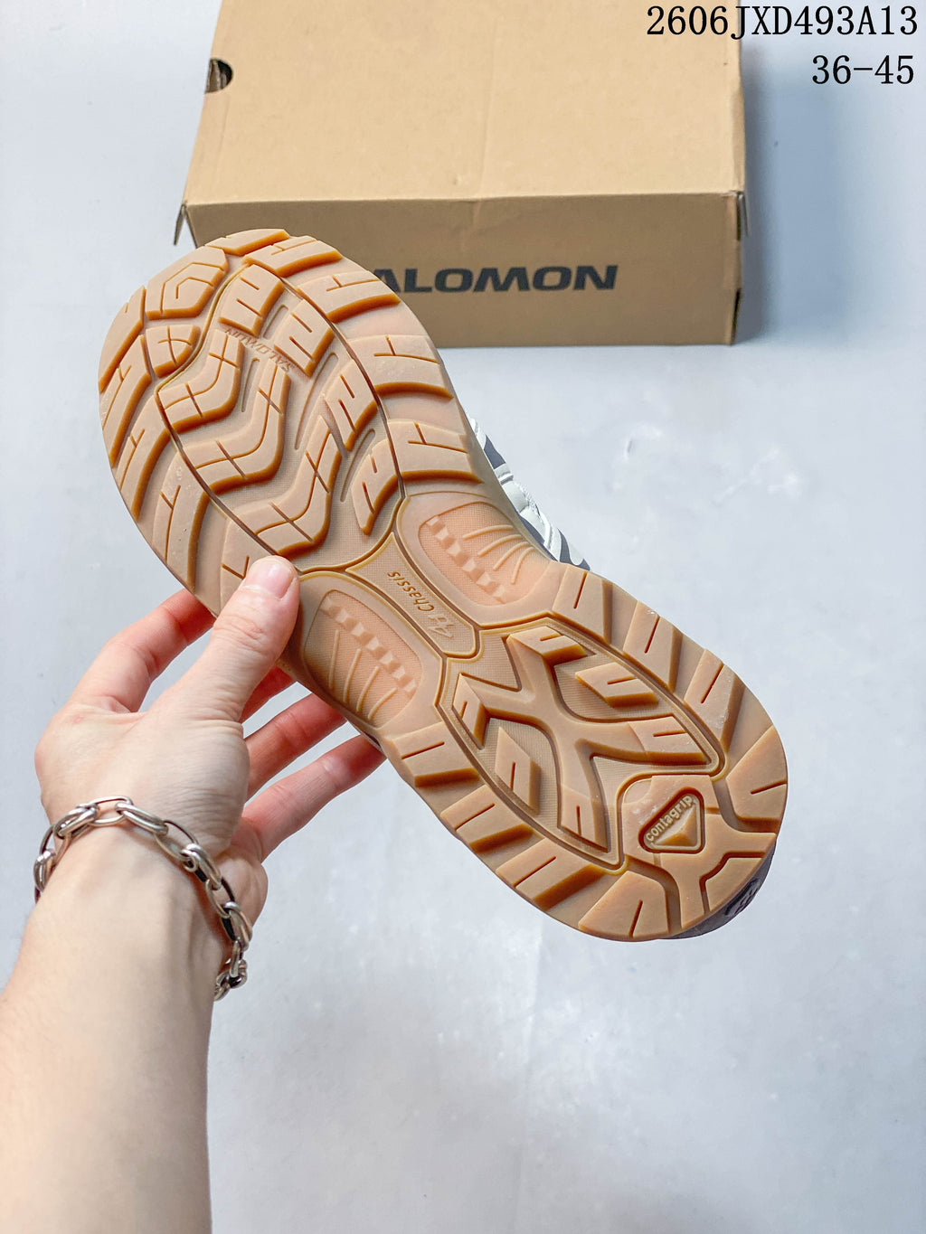 Close-up of the tan outsole tread on a Salomon XA Pro 3D sneaker.