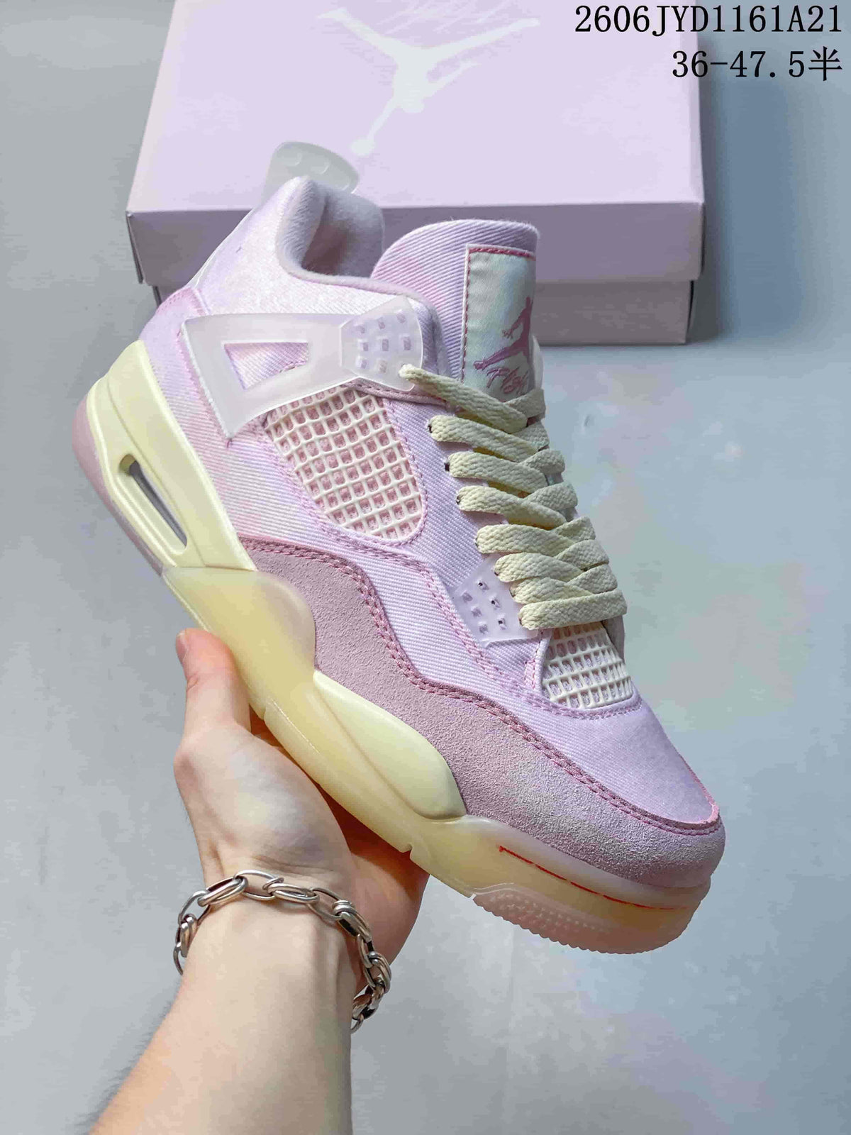 Angled side view of a pink Jordan sneaker with mesh panels, lace wings, and a pale sole.