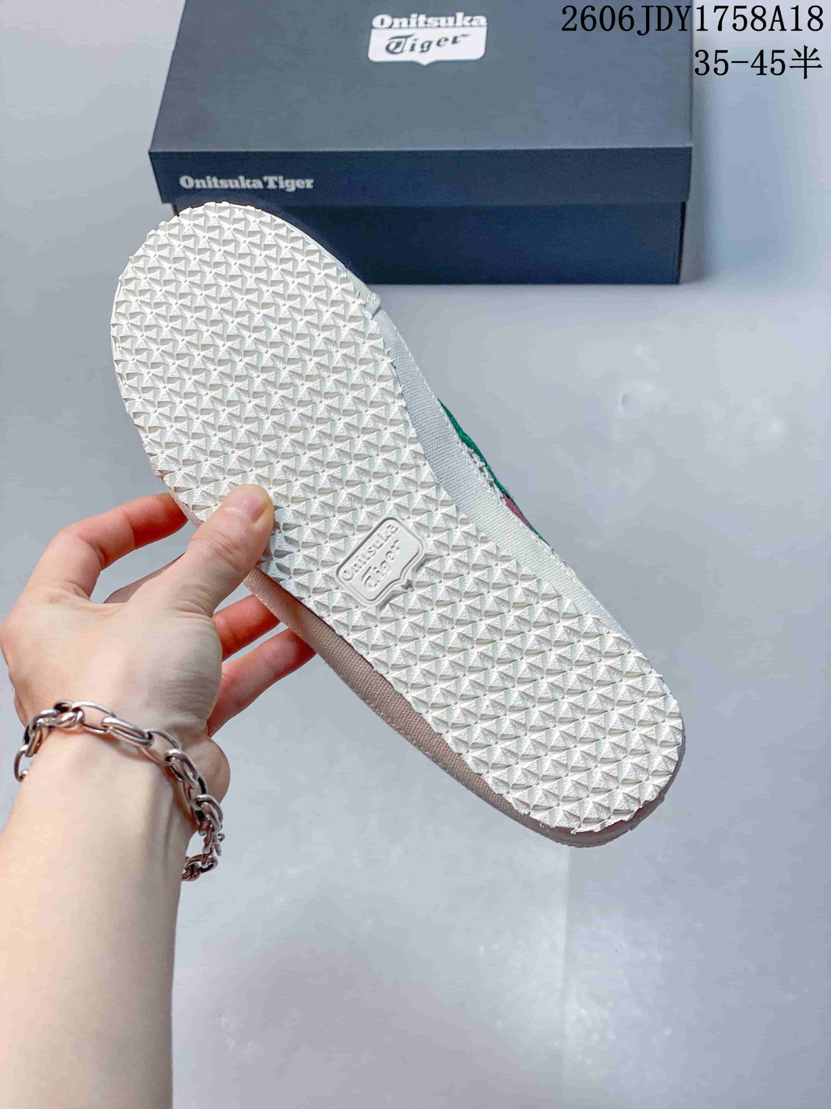 Close-up of the patterned outsole on a cream Onitsuka Tiger Sabot shoe