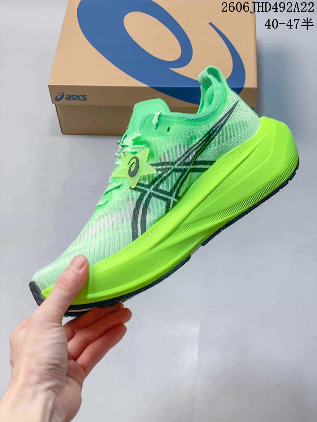 Side view of a green running shoe with dark stripes and a bright lime midsole