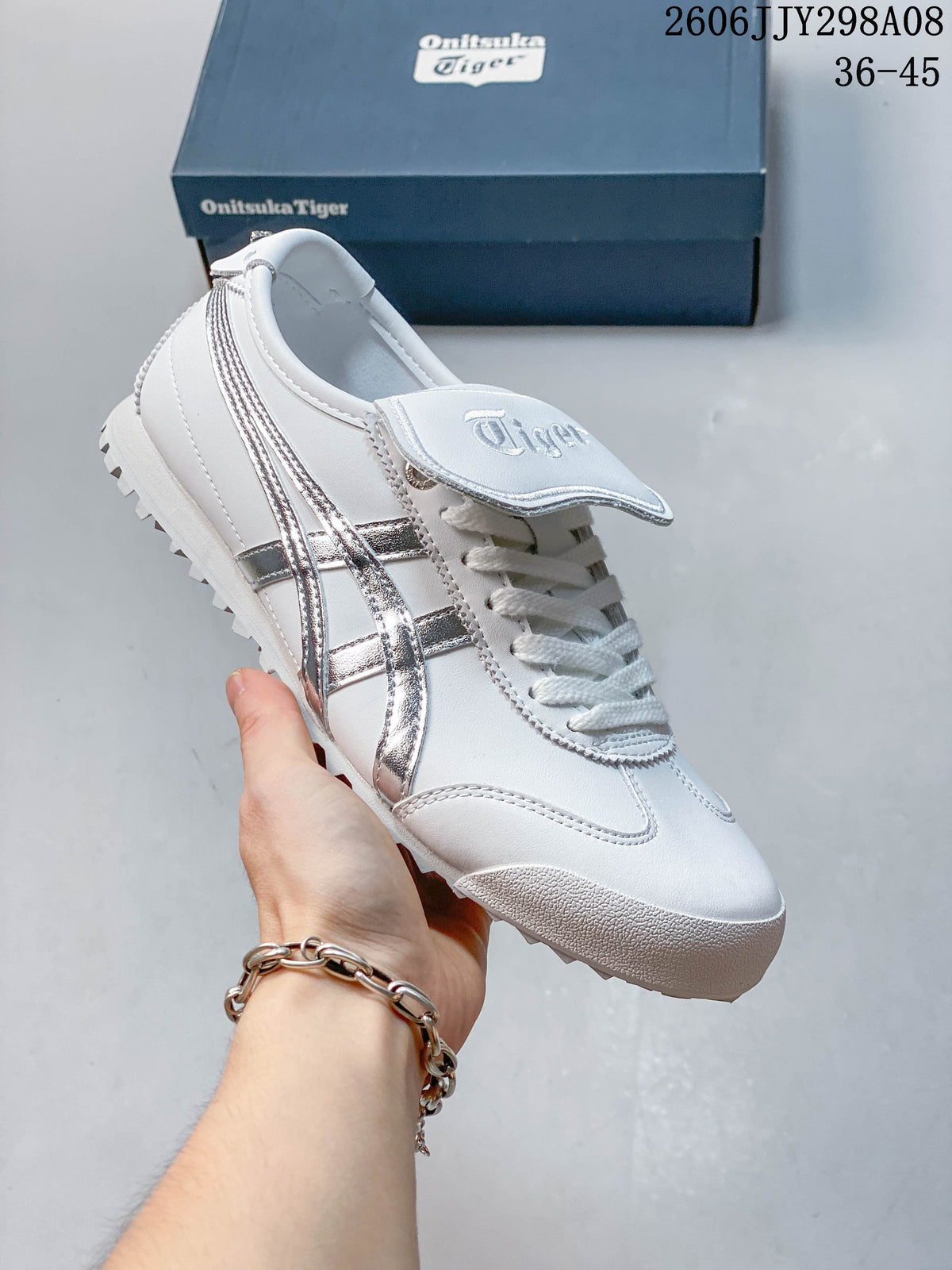 White Onitsuka Tiger Mexico 66 Golf sneaker with metallic-looking side stripes.