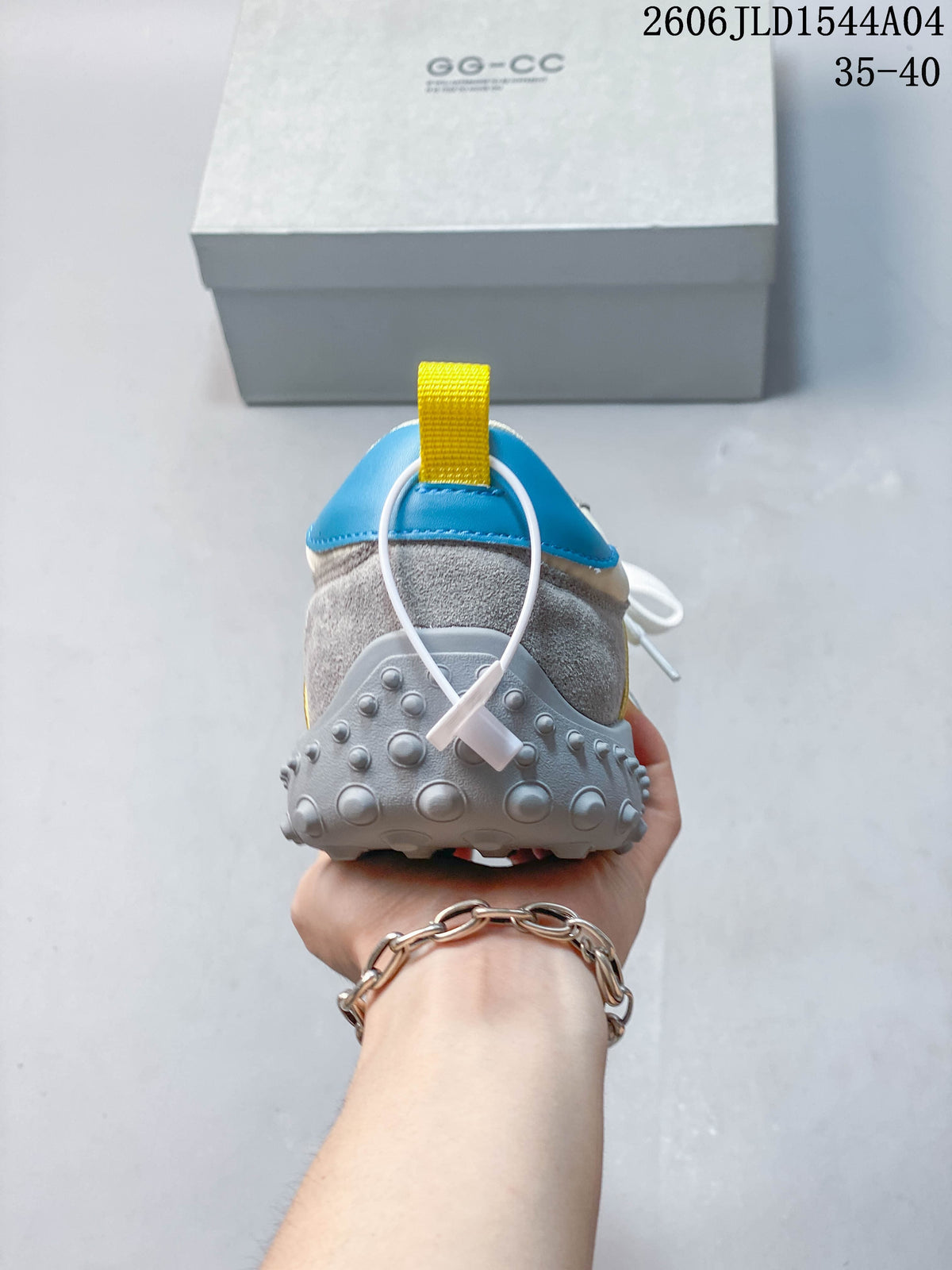 Rear view showing the blue heel panel, yellow pull tab, and textured gray outsole.