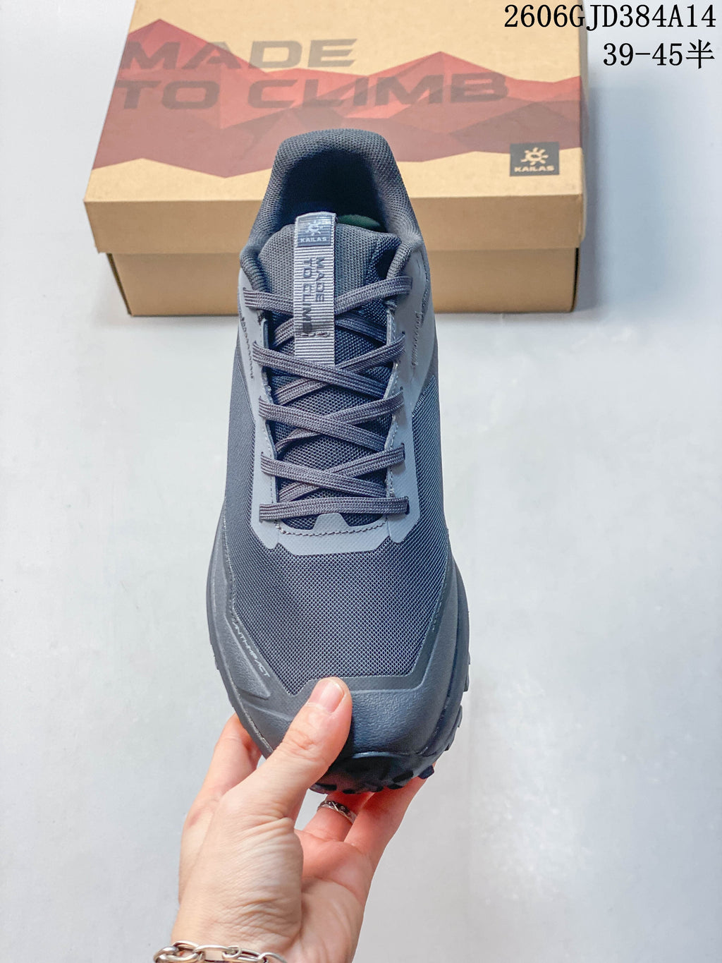Top view of the sneaker showing its laces and gray upper