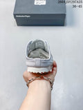 Rear view of a grey and white Onitsuka Tiger Mexico 66 Sabot sneaker held in front of its shoebox; the box shows size range 36–45.