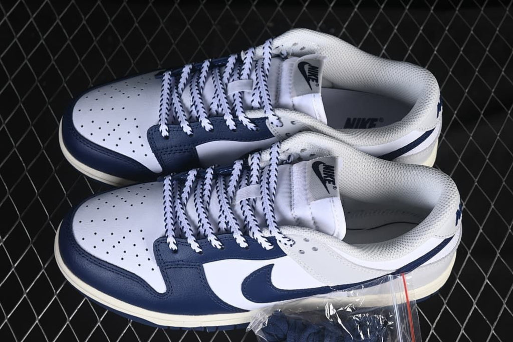 Pair of navy and white low-top sneakers shown from above and the side