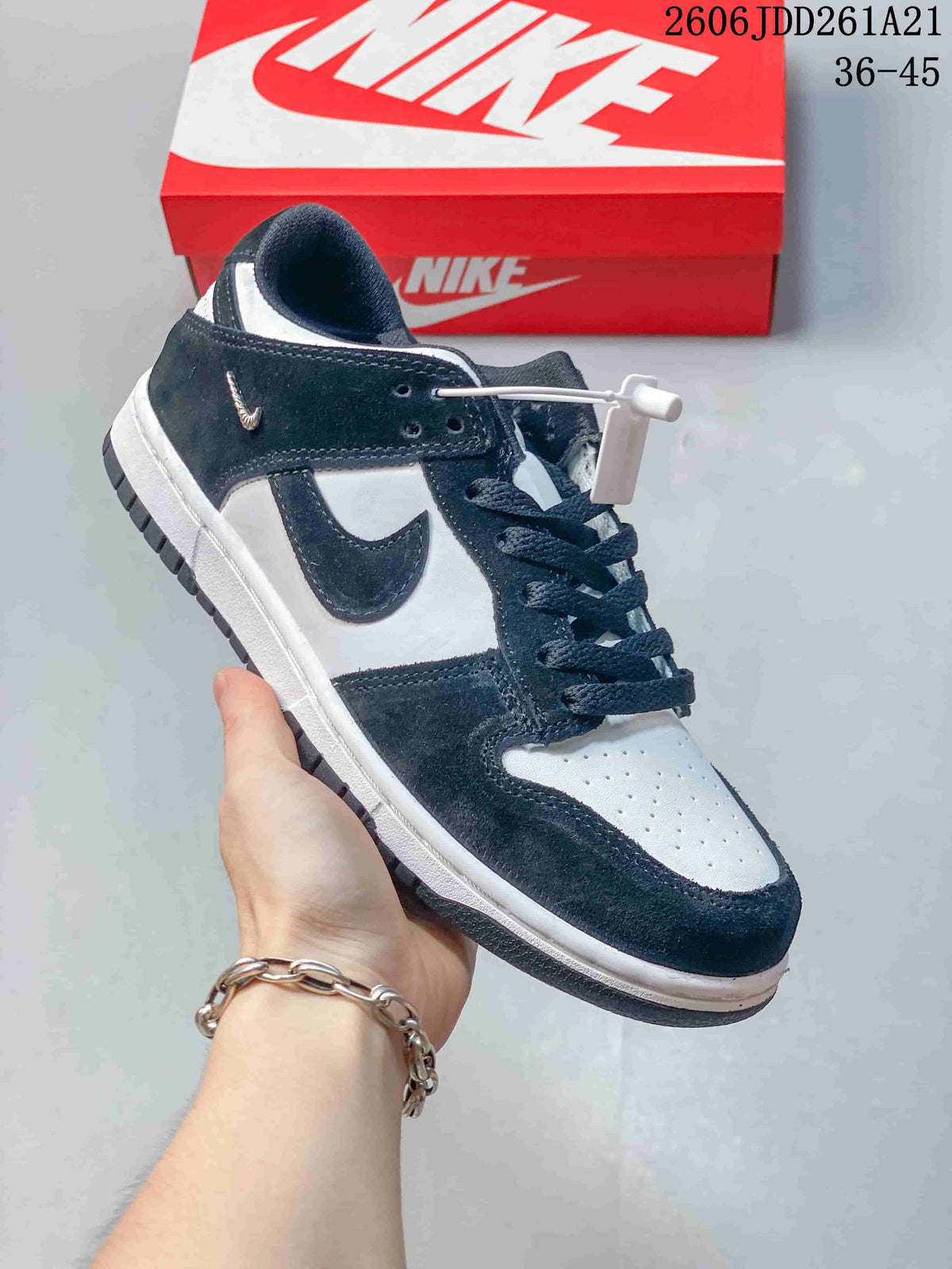 Navy and white low-top Nike Dunk sneaker with dark laces