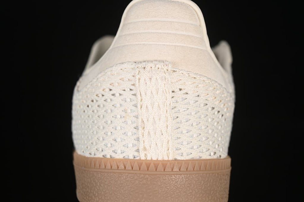 Rear view showing the openwork heel panel and gum-tone outsole.
