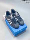 Pair of charcoal adidas Originals Superstar sneakers with white stripes and shell toes