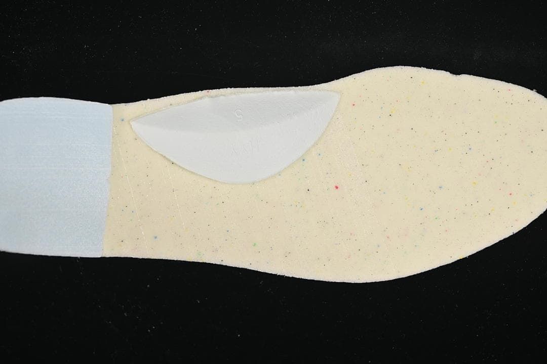 Close-up of the shoe insole showing a light-colored surface