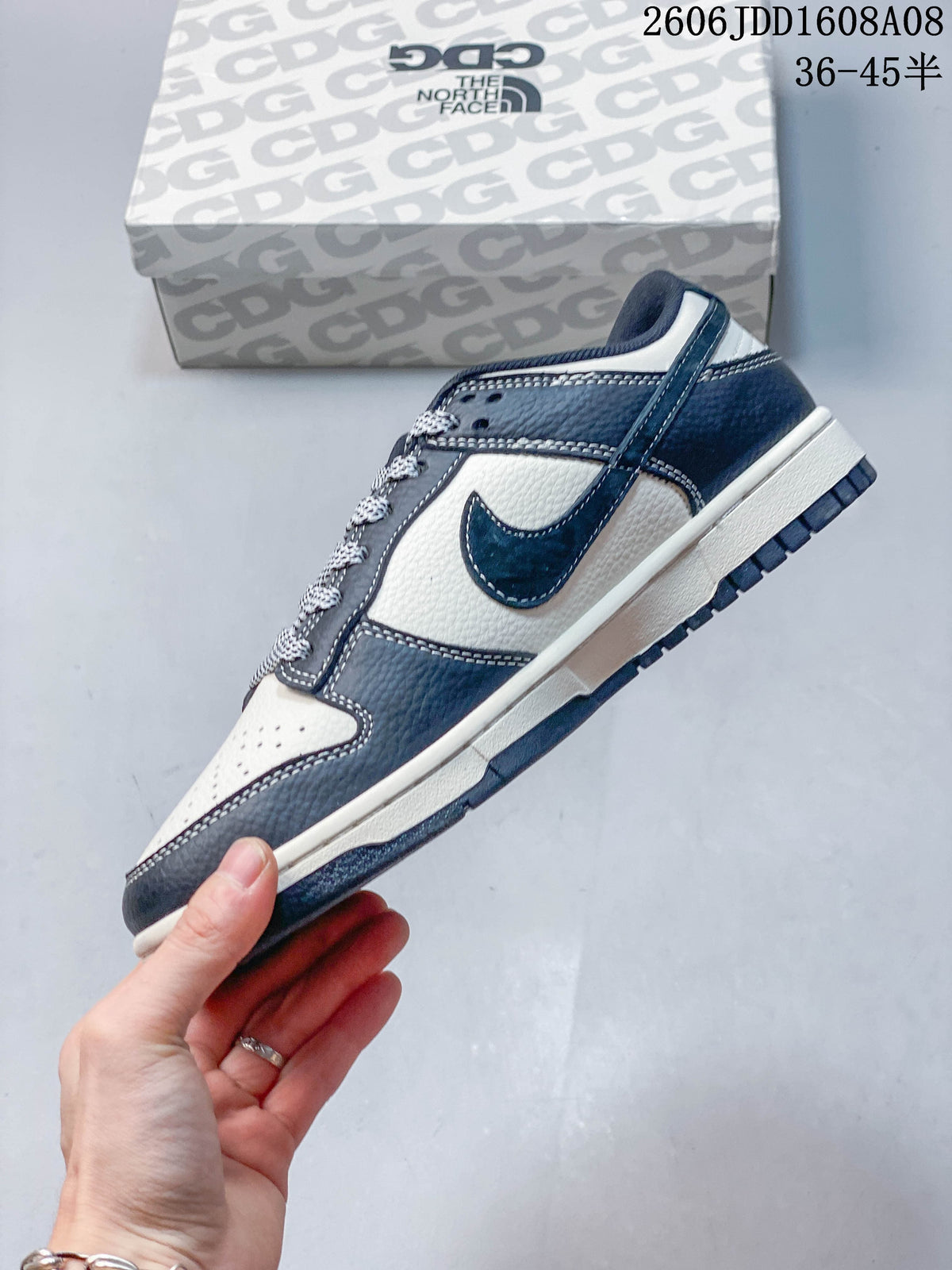 Side view of the navy and cream low-top sneaker with patterned laces