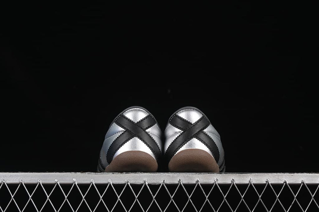 Rear view showing crossed black heel overlays and gum-colored soles