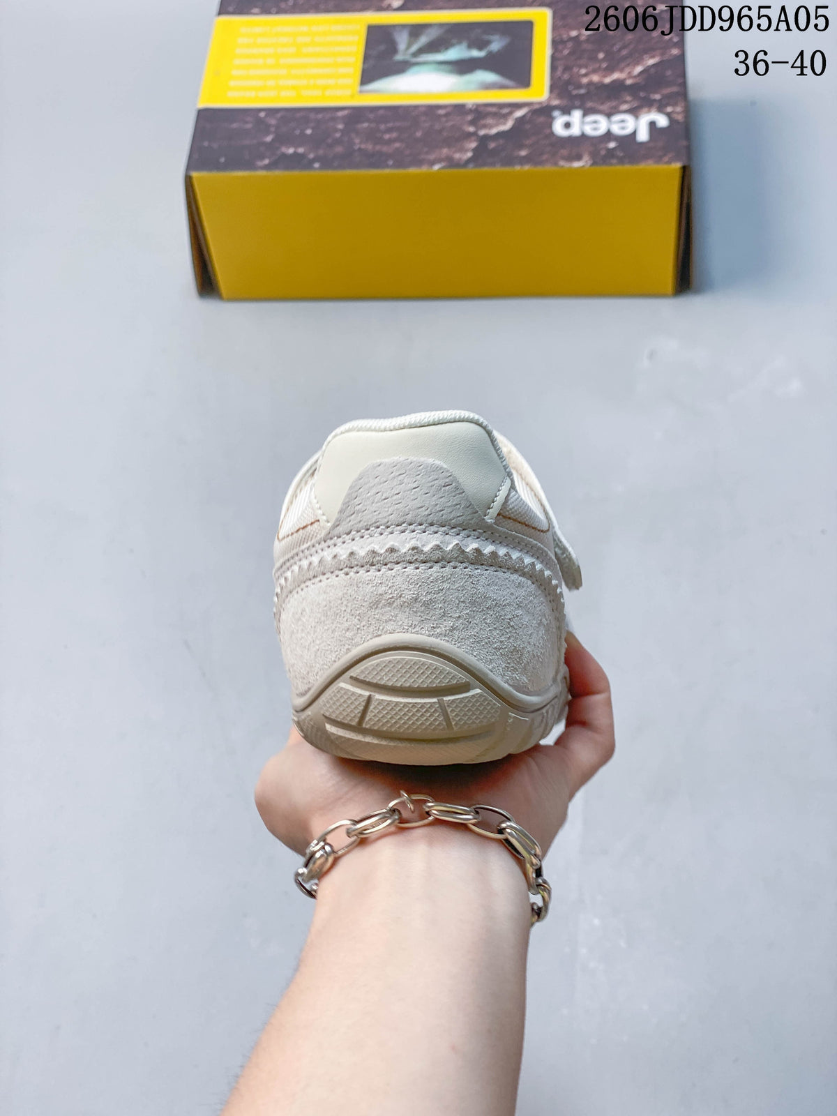 Rear view showing the heel and outsole of the cream shoe