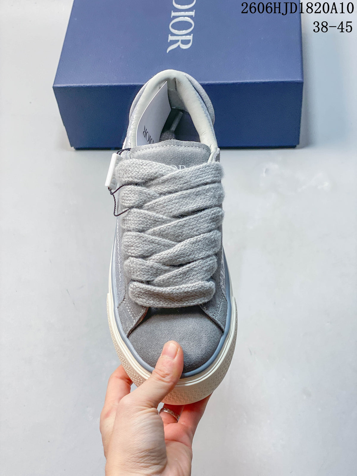 Front view showing the sneaker's wide laces, padded tongue and gray toe