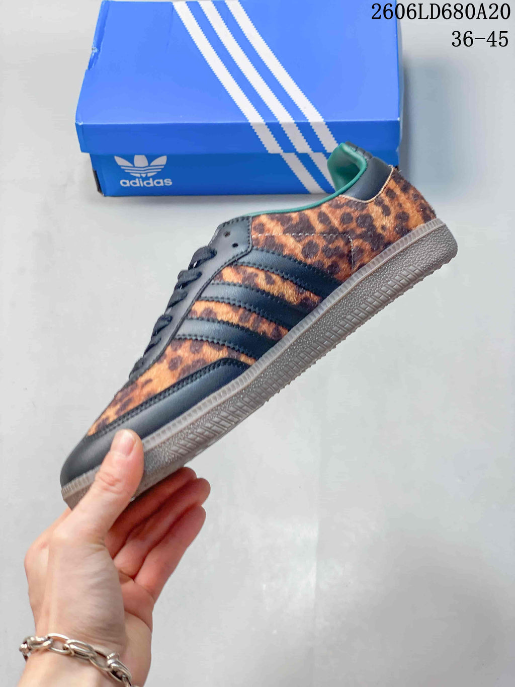 Side view showing leopard-print panels and dark three-stripe detailing