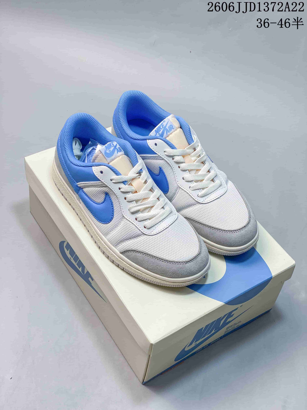 Pair of white, blue, and gray Air Jordan Skyline low-top sneakers on a shoebox