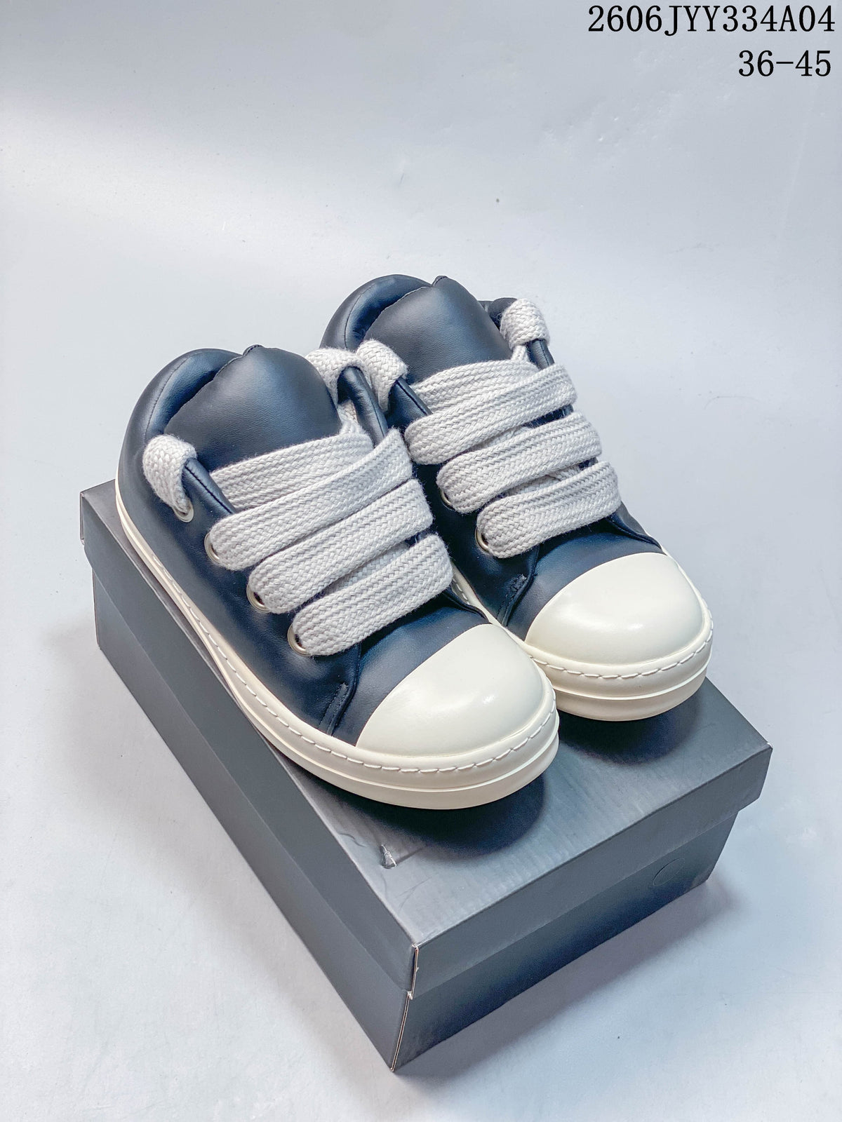 Pair of navy Rick Owens low-top sneakers with oversized ivory laces and toe caps