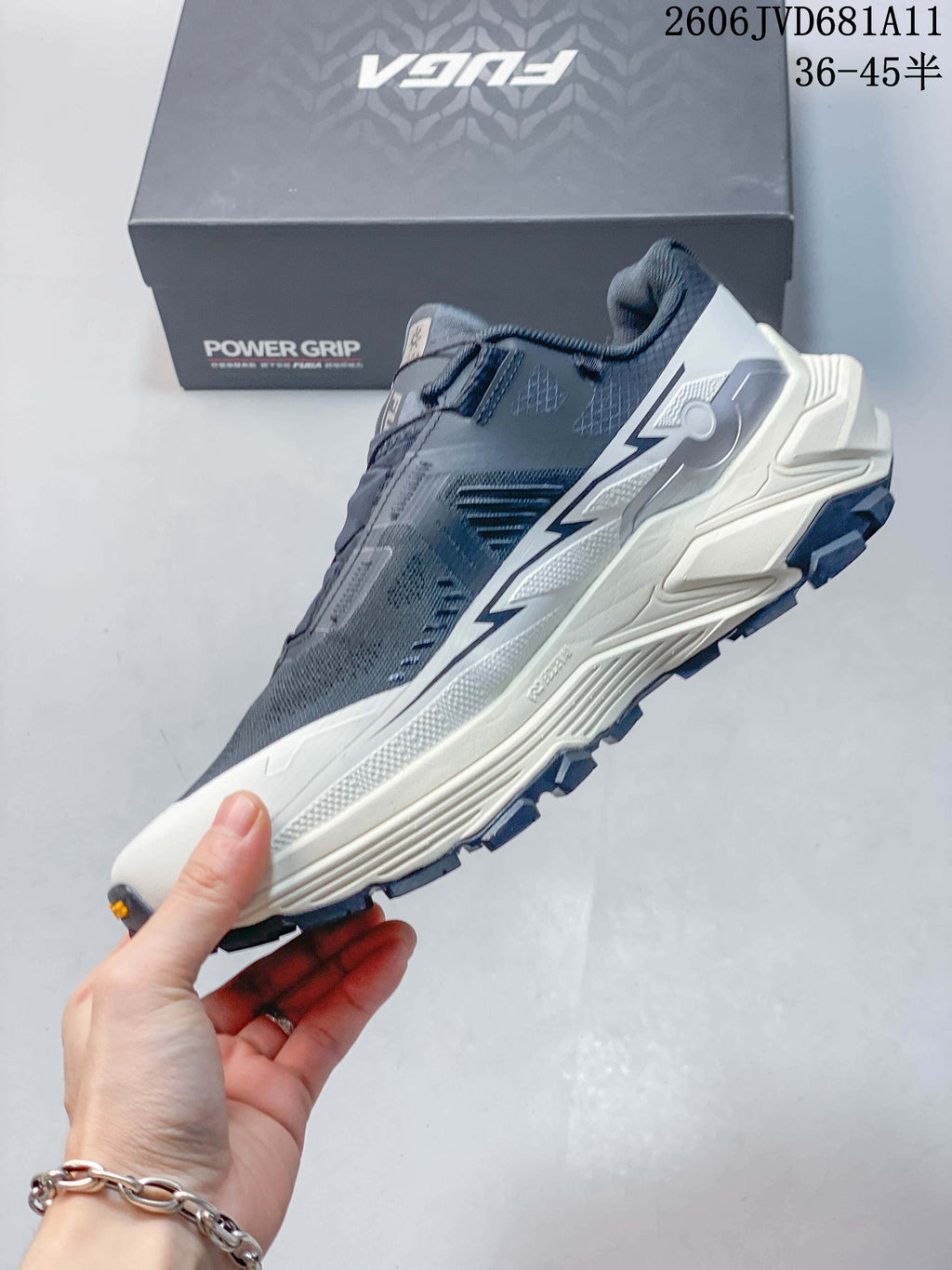 Side view of the blue and white trail shoe with dial closure.