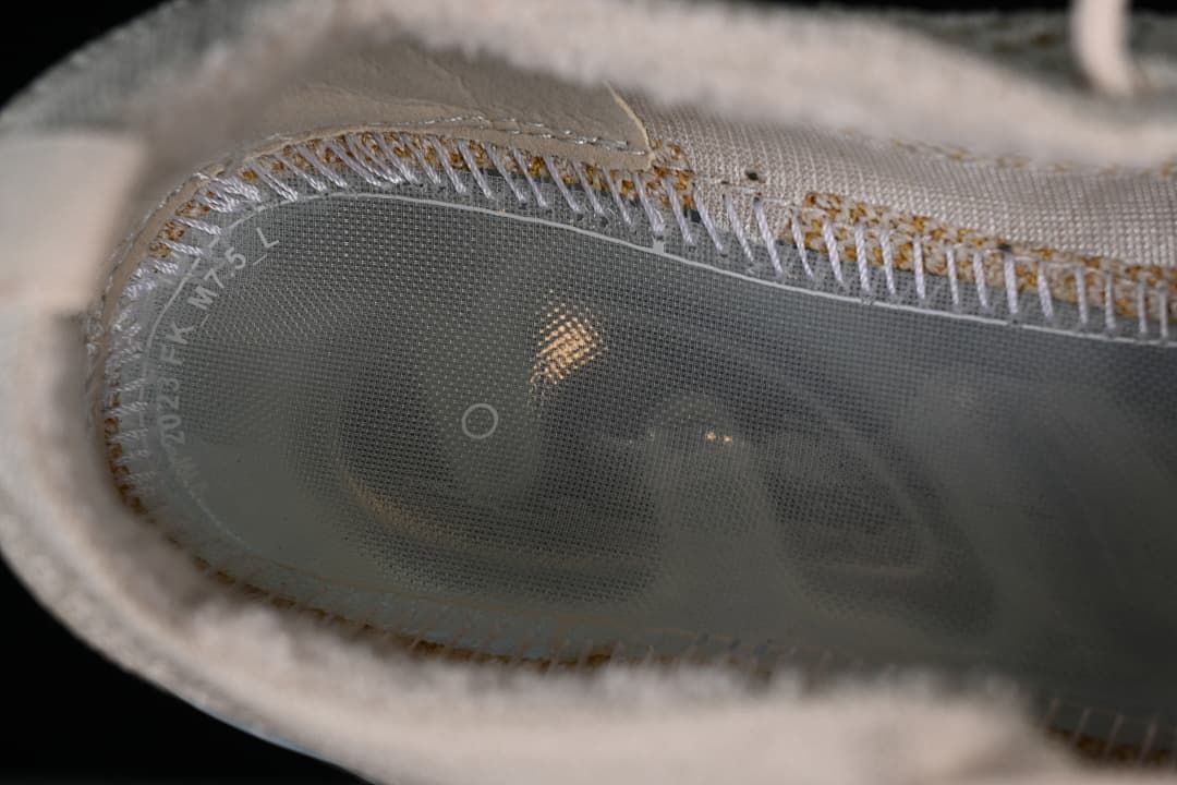 Close-up inside the shoe showing the insole and knit upper construction.