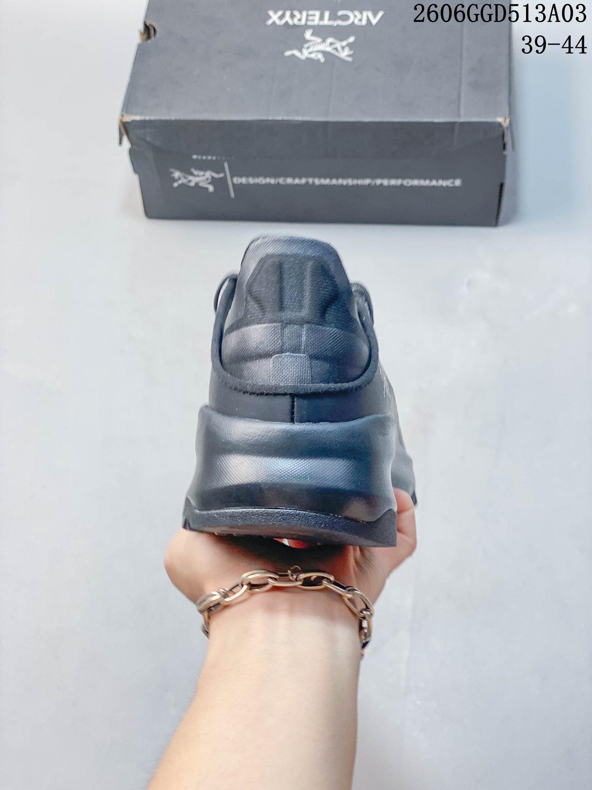 Rear view of a dark gray low-cut outdoor shoe