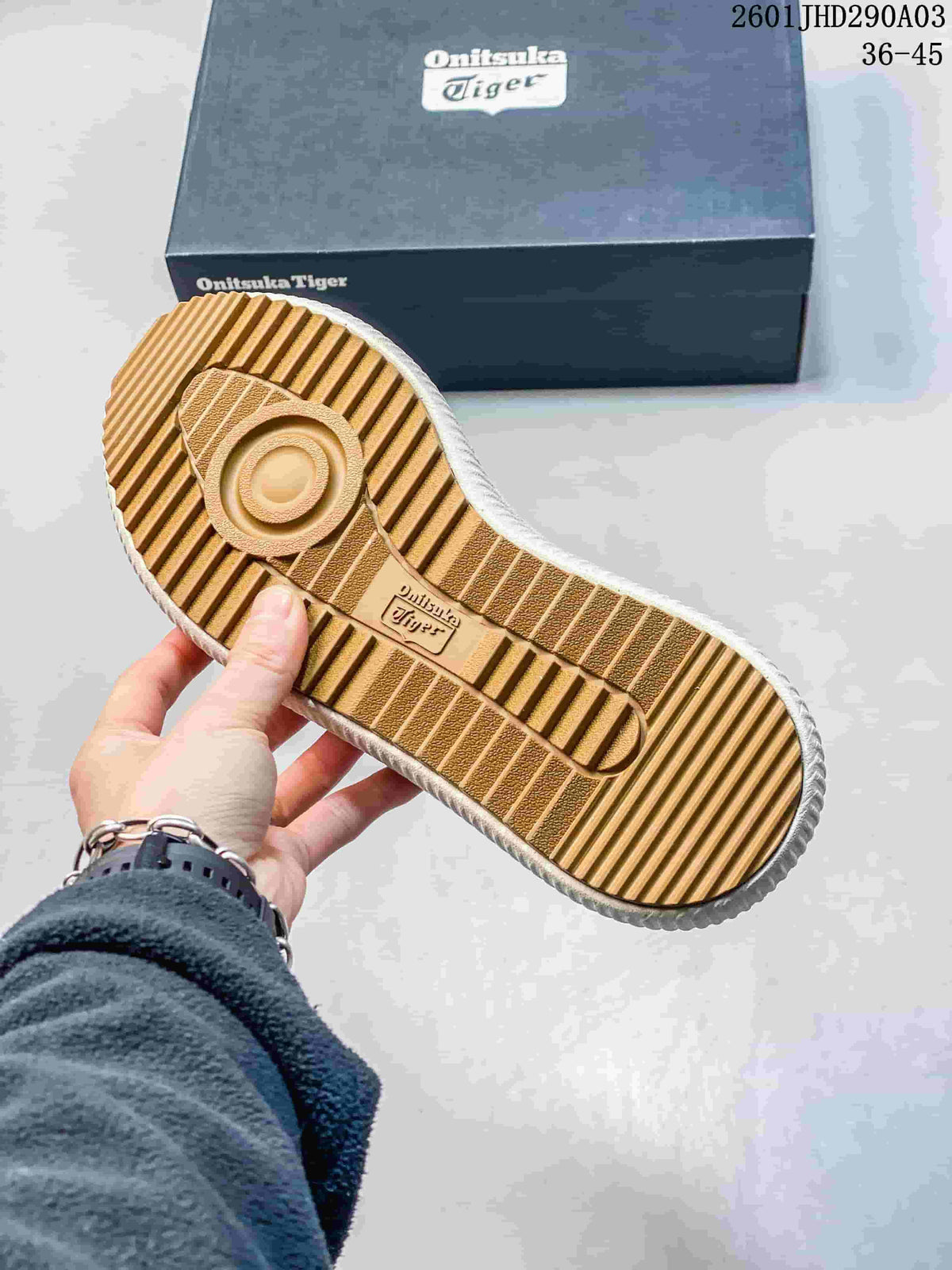 Underside of the sneaker showing a gum-tone tread outsole beside an Onitsuka Tiger shoebox