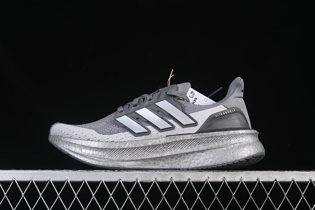 Side view of grey adidas Ultraboost 5 running shoe with silver-toned midsole