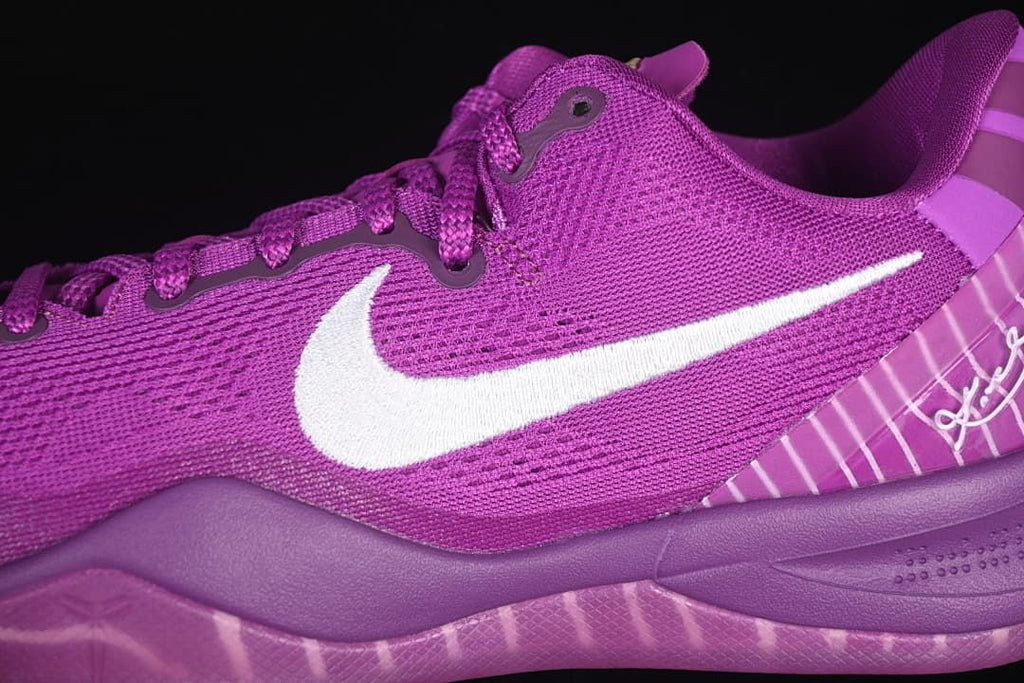 Close-up of the purple mesh upper, laces, and white Swoosh