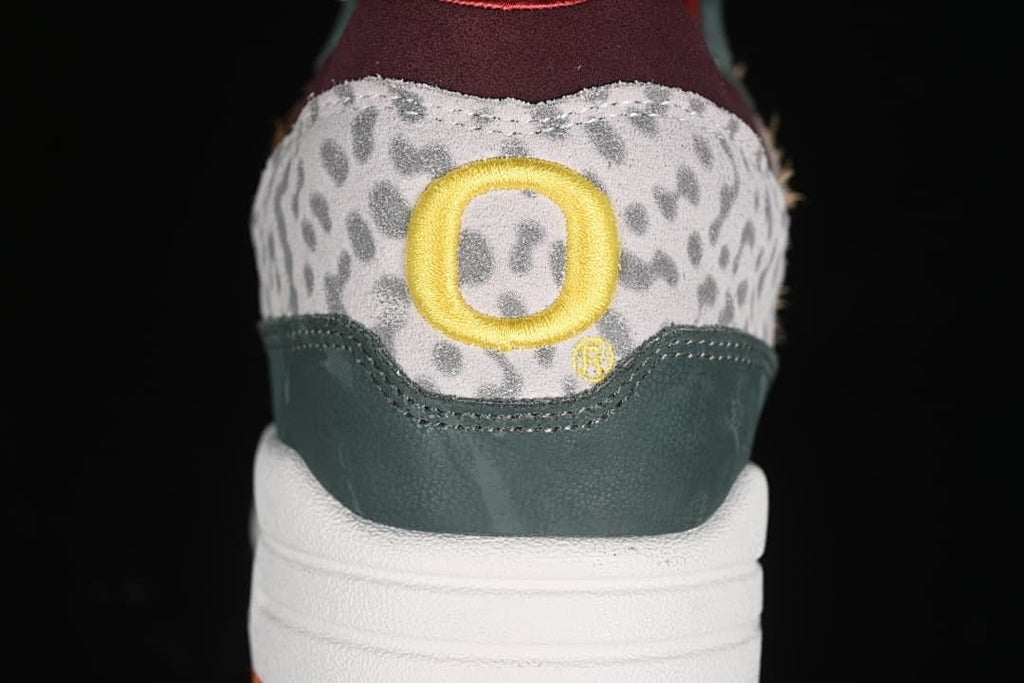 Rear view showing the patterned heel panel and yellow embroidered detail.