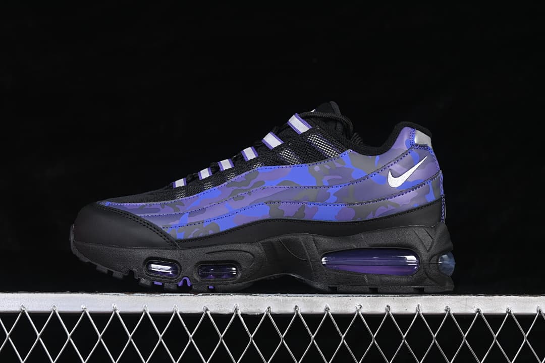 Side view of a Nike Air Max 95 sneaker with blue and purple camouflage-style panels, silver swoosh, and black sole
