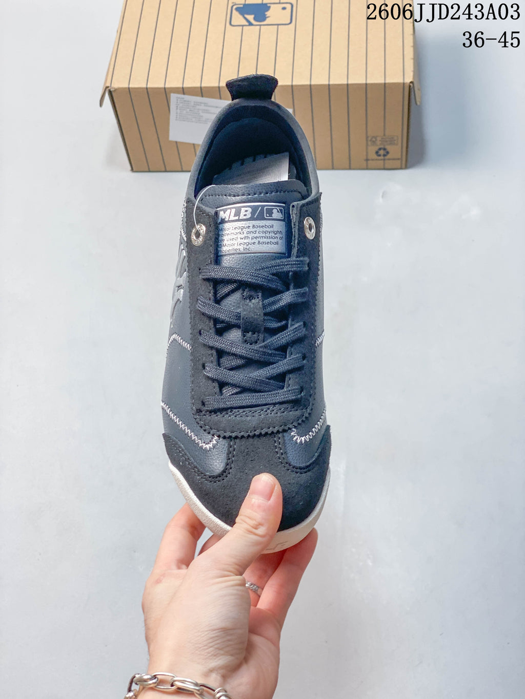 Front view of a navy lace-up sneaker with an MLB tongue label