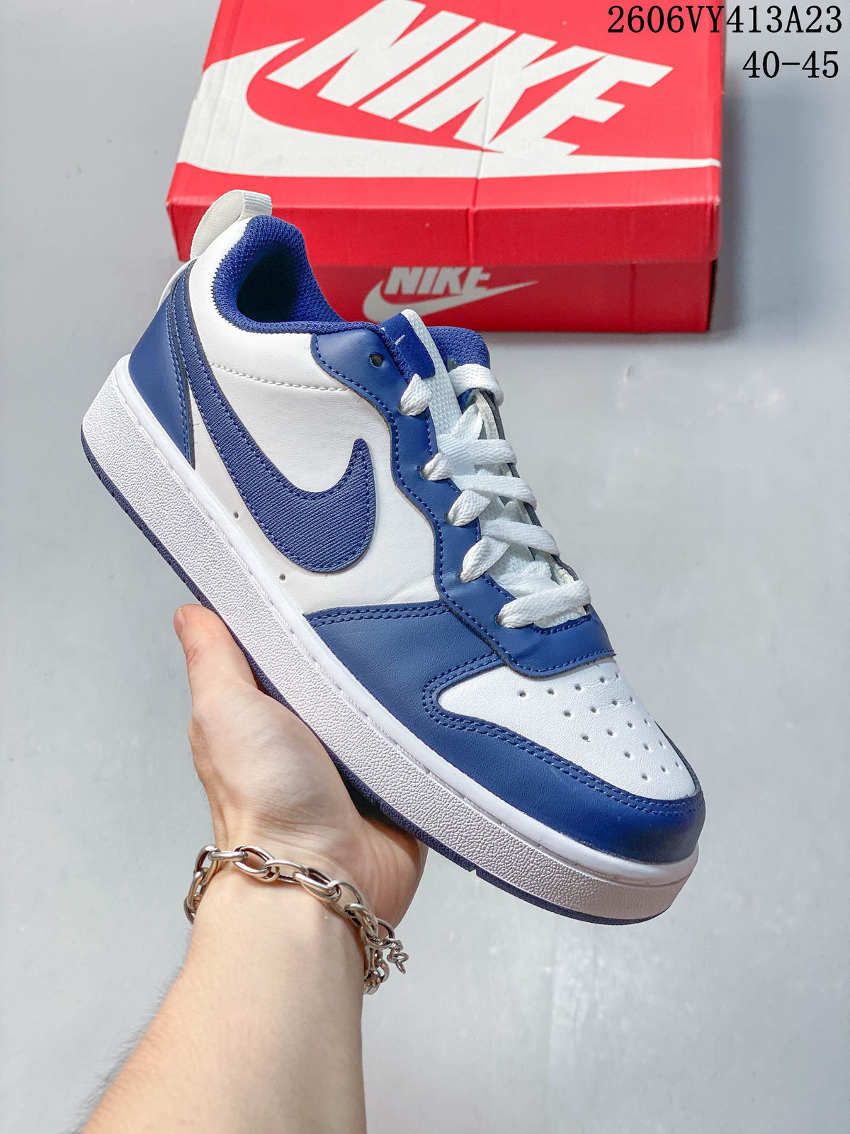 White sneaker with blue overlays and a blue Swoosh