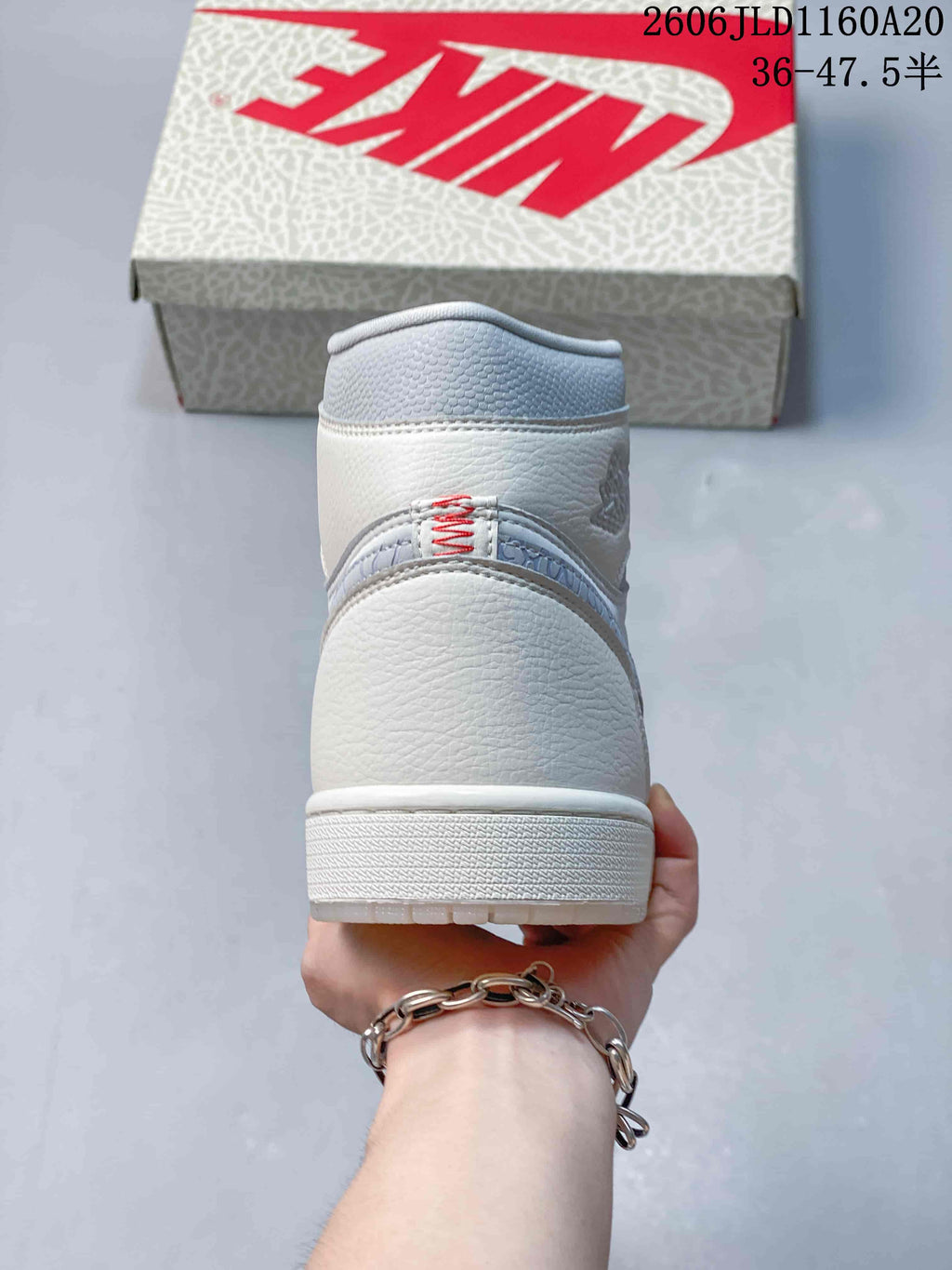 Rear view of a white and grey Air Jordan 1 high-top sneaker