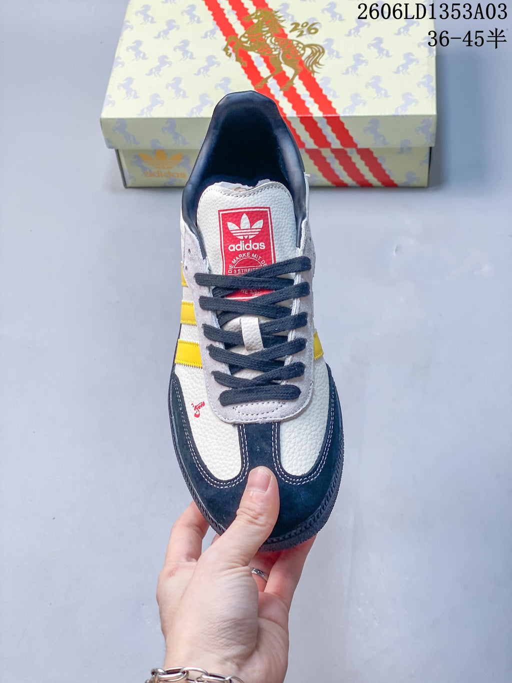Top view of the sneaker showing its dark laces, red tongue label and navy toe overlays.