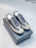 Gray and dark blue ECCO low-top lace-up sneakers with contrast panels, shown on a shoe box.