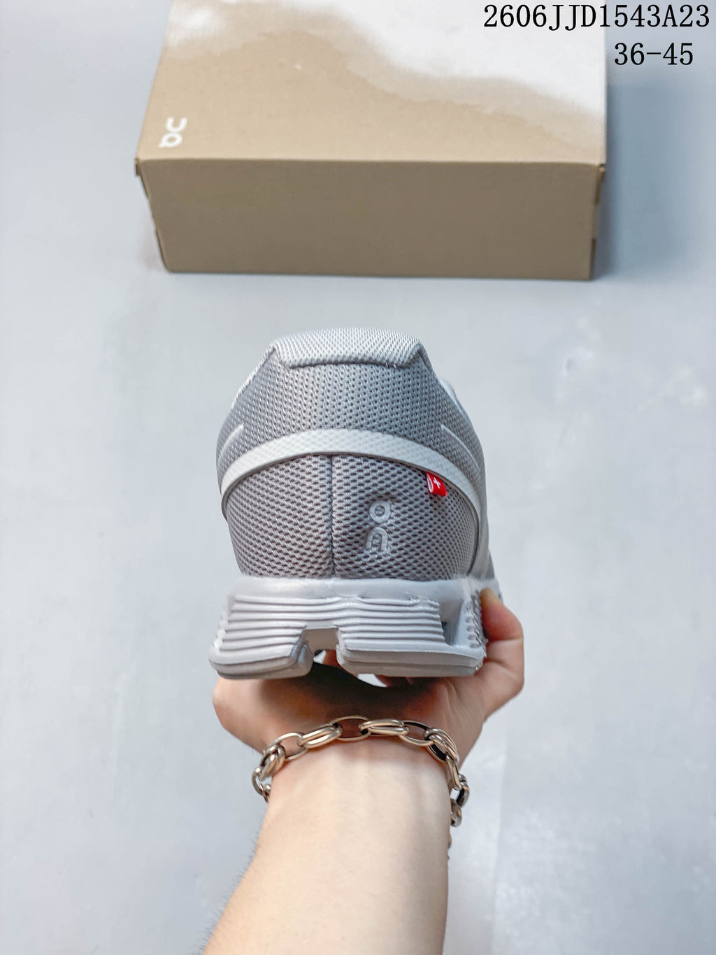Rear view of the grey sneaker showing the heel and outsole.