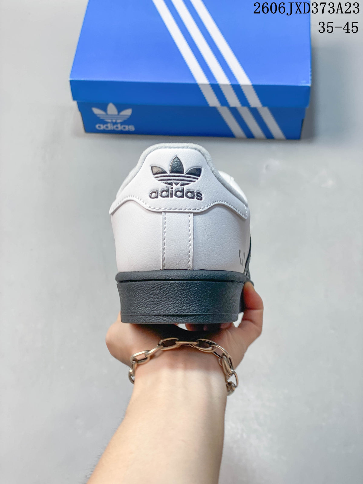 Rear view showing the Adidas trefoil heel detail and dark outsole.
