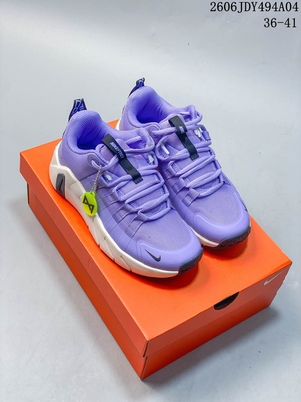 Pair of purple Nike Free Metcon 7 training shoes shown on an orange shoe box.