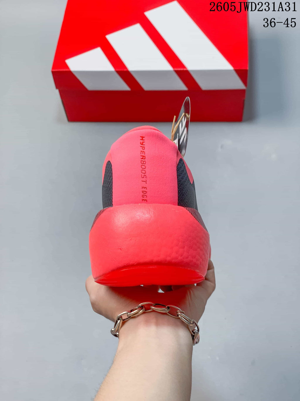 Rear view of the bright pink shoe with Hyperboost EDGE text visible on the tongue.