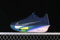 Side profile of a navy Nike running shoe with a pale swoosh, lime accents, and a sculpted pink and blue sole.
