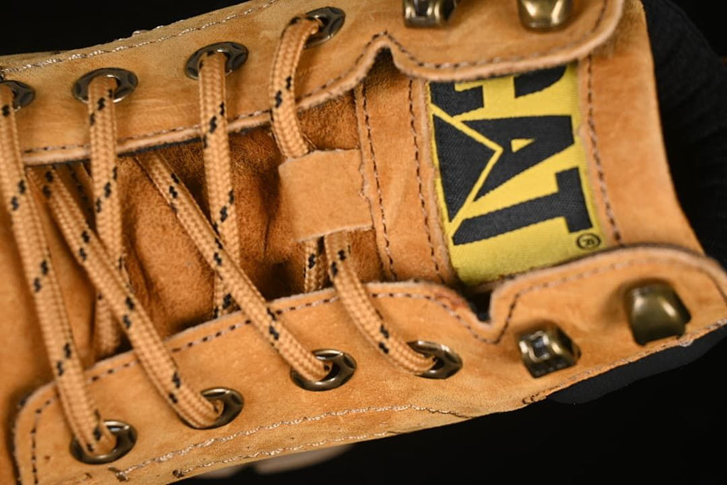 Close-up of the CAT tongue label, lace hooks, and laces
