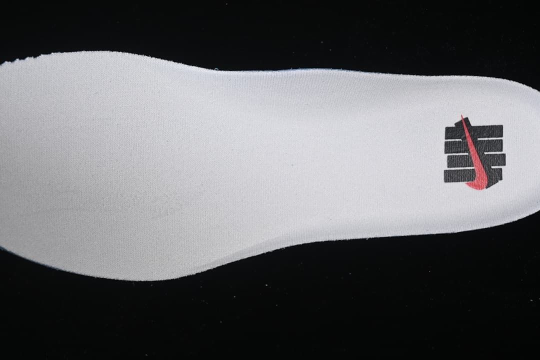 White insole with a black and red graphic.