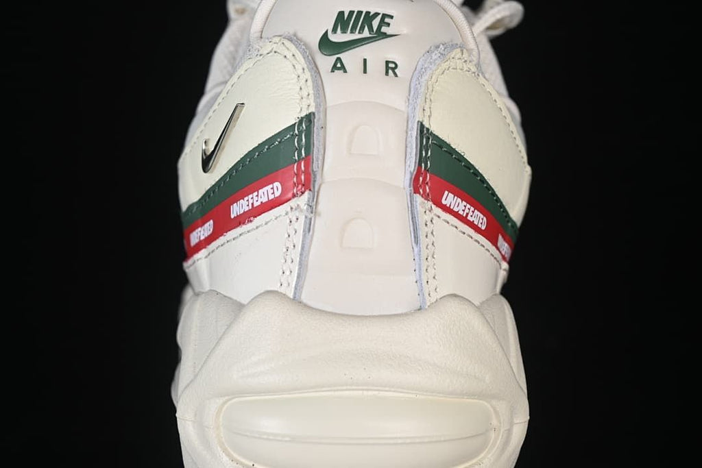 Rear view showing Nike Air branding and red and green Undefeated side stripes.