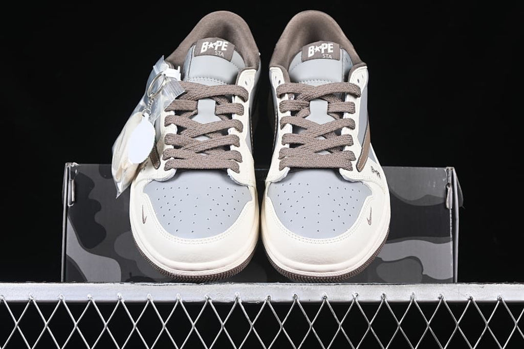 Front view of the pair showing perforated gray toe panels and brown laces.