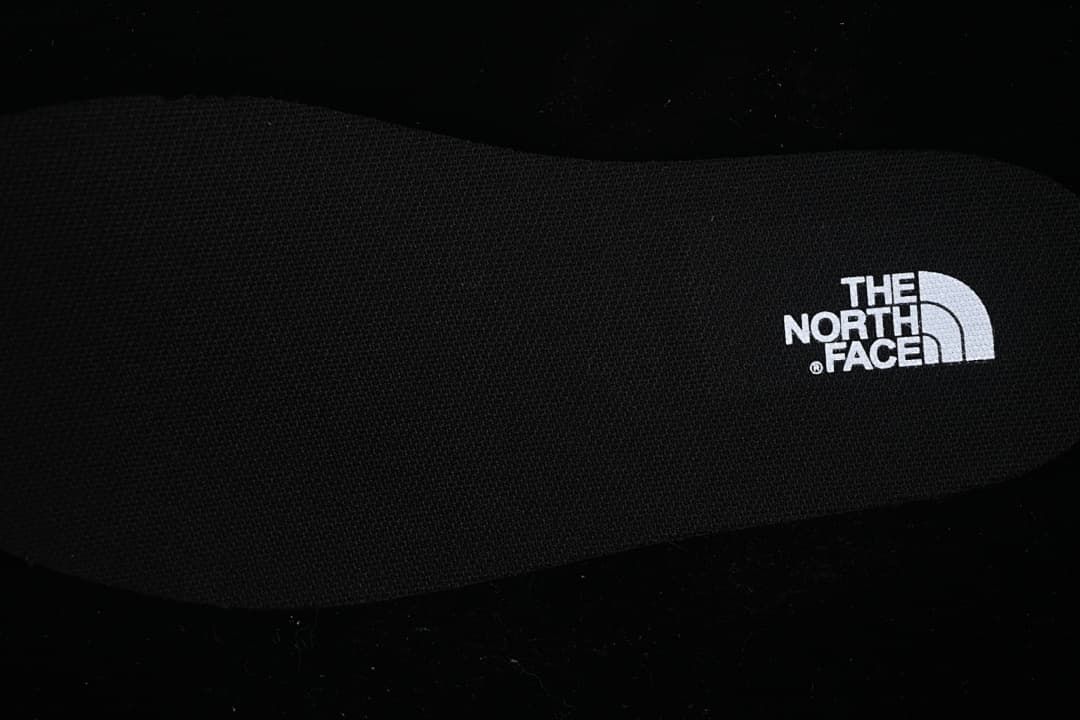 Black footbed with The North Face logo.